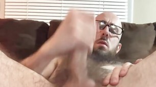 Very hairy bald daddy with glasses inserts a butt plug and jerks off big uncut cock to satisfying cumshot